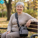 Older woman sitting on park bench wearing nasal cannula and houndstooth portable oxygen bag